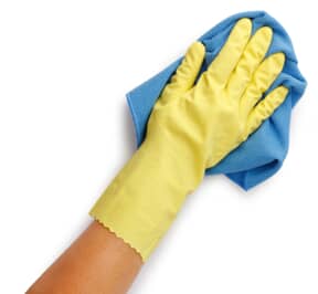 Pearson cleaning with a blue rag while wearing a yellow glove